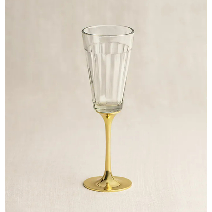 A set of two Chai glasses are held by an elegant brass stem, the perfect height to sip champagne.